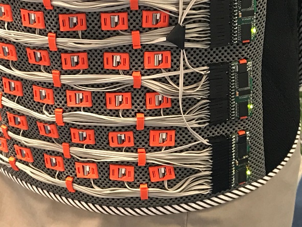 A close up picture of circuitboards and wires connected to small vibration motors