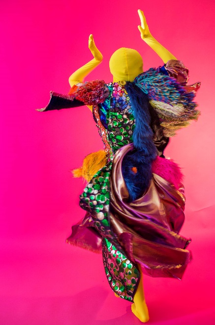 A mannequin wearing a flowing, multicolored dress