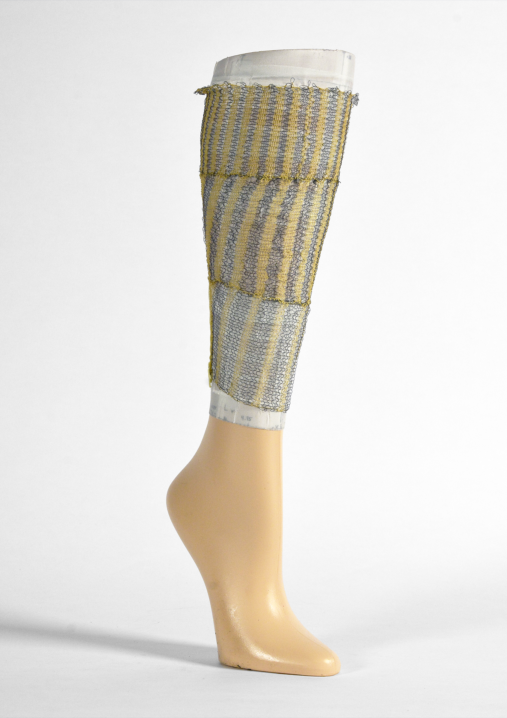 An artificial leg with knit fabric wrapped around the calf